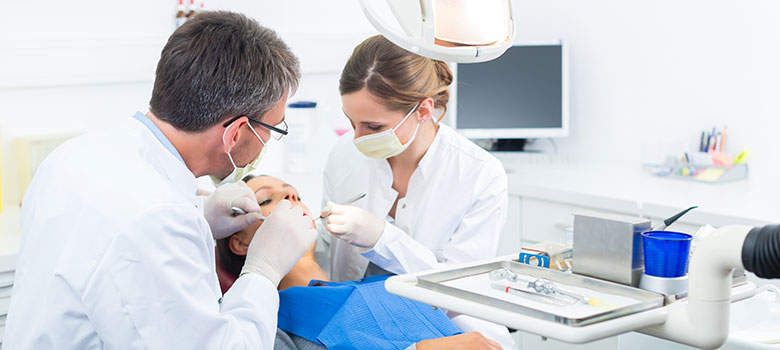 Dentist and hygienist with patient in dental chair