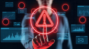 A person touching a red warning sign surrounded by data graphs and email icons on a dark background